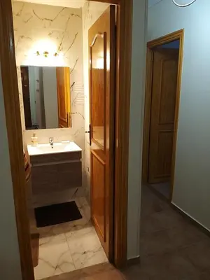 a bathroom with a sink and a mirror at Sweet home in Marrakech