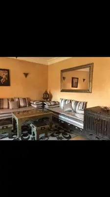 a room with couches and a table and a mirror at مراكش in Marrakech