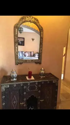 a wooden dresser with a mirror on top of it at مراكش in Marrakech