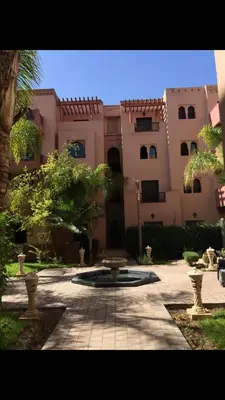 a building with a fountain in the middle of a courtyard at مراكش in Marrakech
