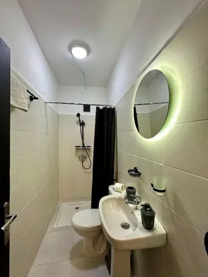 a bathroom with a sink and a toilet and a mirror at Luxury Appartement Marjane in Marrakech