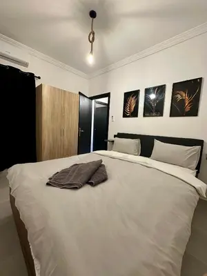 a bedroom with a large white bed with towels on it at Luxury Appartement Marjane in Marrakech