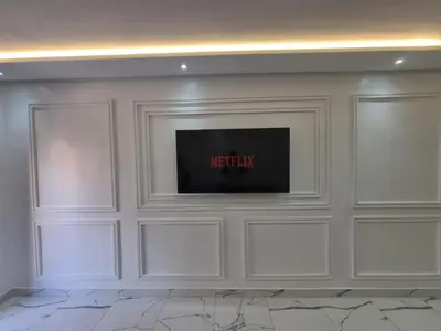 a living room with a television on a wall at Kech vacations FRIENDLY! 2 bedroom luxury apartment in Marrakech