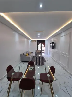 a living room with a glass table and chairs at Kech vacations FRIENDLY! 2 bedroom luxury apartment in Marrakech