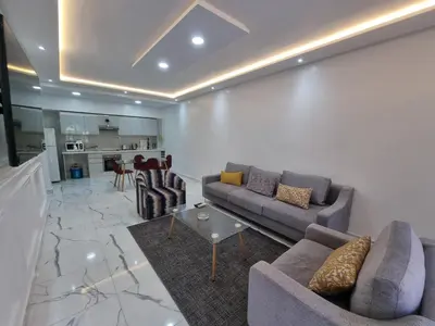 a living room with two couches and a kitchen at Kech vacations FRIENDLY! 2 bedroom luxury apartment in Marrakech