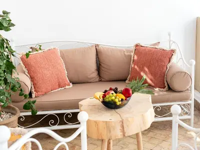a living room with a couch and a table with a bowl of fruit at Riad Melina Au Coeur de la Medina Petit Dejeuner in Marrakech