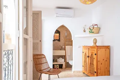 a room with a bathroom with a chair and a mirror at Riad Melina Au Coeur de la Medina Petit Dejeuner in Marrakech