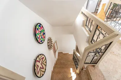 a staircase with two stained glass windows on the wall at Riad Melina Au Coeur de la Medina Petit Dejeuner in Marrakech