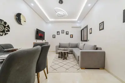 a living room with a couch and chairs at Confortable & Très Bien Noté - Vue Piscine, Proche M Avenue, Piscine, Fibre Optique, Parking in Marrakech