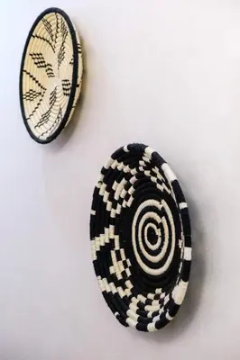 two rocks on a white wall with a black and white shell at Confortable & Très Bien Noté - Vue Piscine, Proche M Avenue, Piscine, Fibre Optique, Parking in Marrakech