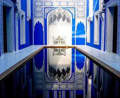 a blue and white room with a table in the water at Riad Goloboy in Marrakech