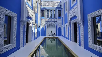 a blue and white building with a swimming pool at Riad Goloboy in Marrakech