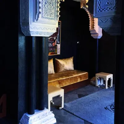 a living room with a couch and a column at Riad Goloboy in Marrakech