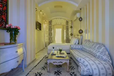 a living room with a couch and a table at Riad Goloboy in Marrakech
