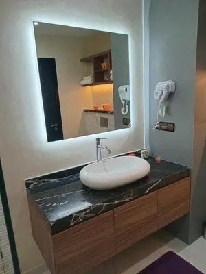 a bathroom with a sink and a mirror at Luxury Apartment with swimming pool in Gueliz Marrakech in Marrakech