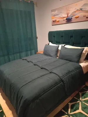 a large bed with a green headboard in a room at Luxury Apartment with swimming pool in Gueliz Marrakech in Marrakech