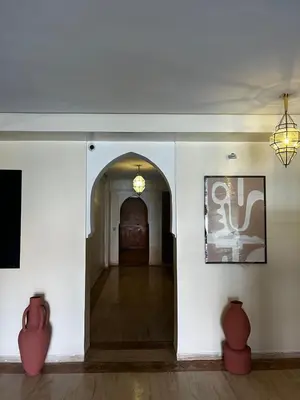 a hallway in a building with vases at Luxury Apartment with swimming pool in Gueliz Marrakech in Marrakech