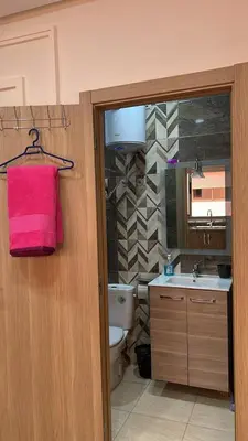 a bathroom with a sink and a pink towel at Appartement de haute standing in Marrakech