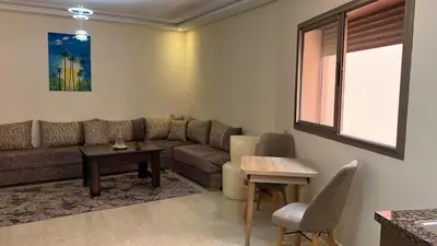 a living room with a couch and a table at Appartement de haute standing in Marrakech
