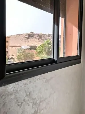 a window in a room with a view of a mountain at Marrakech appart in Marrakech