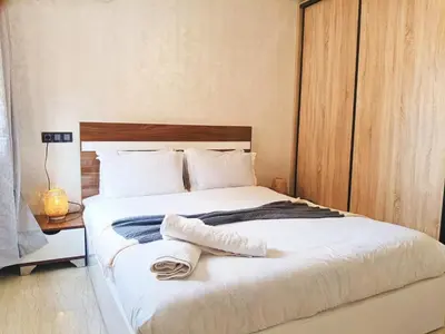 a bedroom with a large bed with towels on it at Marrakech appart in Marrakech