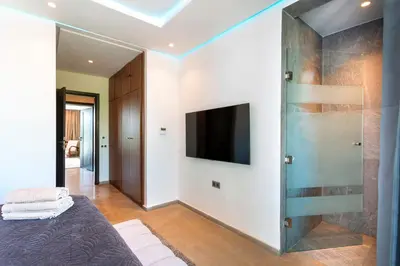 a bedroom with a flat screen tv and a bed at Villa Argana moderne et luxueuse piscine chauffée in Marrakech
