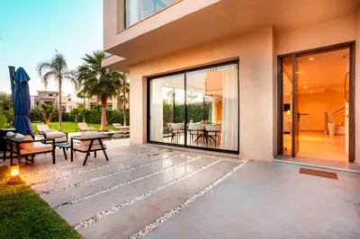 a patio with a view of a house at Villa Argana moderne et luxueuse piscine chauffée in Marrakech