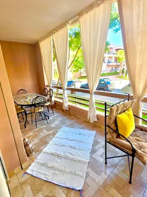 a living room with a large window and a table at Riad Garden Luxury Aparts by SABOR VOYAGE in Marrakech