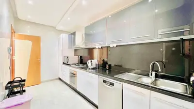 a kitchen with white cabinets and a sink at Riad Garden Luxury Aparts by SABOR VOYAGE in Marrakech