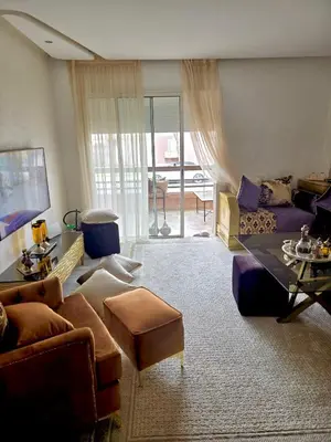 a living room with a couch and a table at Riad Garden Luxury Aparts by SABOR VOYAGE in Marrakech