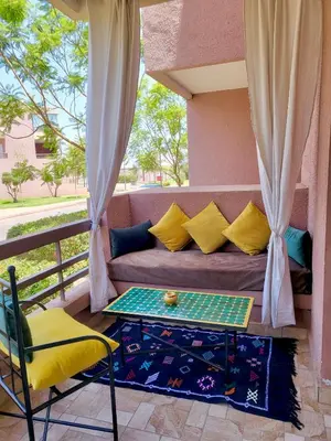 a couch and a table on a balcony at Riad Garden Luxury Aparts by SABOR VOYAGE in Marrakech