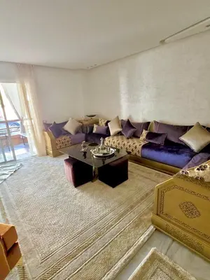 a living room with a couch and a table at Riad Garden Luxury Aparts by SABOR VOYAGE in Marrakech