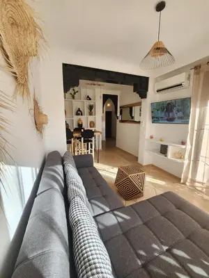 a living room with a couch and a table at Dar Atlas Lula in Marrakech