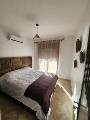 a bedroom with a large bed and a window at Dar Atlas Lula in Marrakech