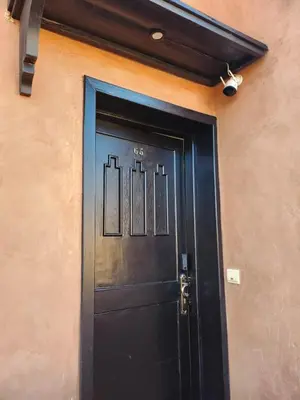 a black door with the number eighty on it at Dar Atlas Lula in Marrakech