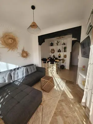 a living room with a couch and a table at Dar Atlas Lula in Marrakech
