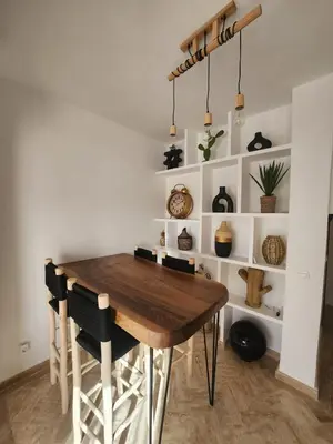 a dining room with a wooden table and chairs at Dar Atlas Lula in Marrakech