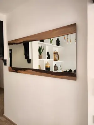 a mirror hanging on a wall with plants on it at Dar Atlas Lula in Marrakech