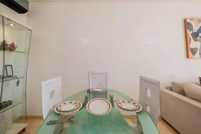 a glass table with two plates on top of it at Appartement de prestige au golf in Marrakech