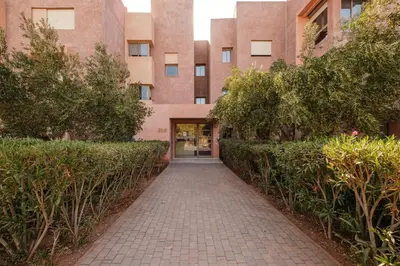 a brick walkway in front of a building at Appartement de prestige au golf in Marrakech