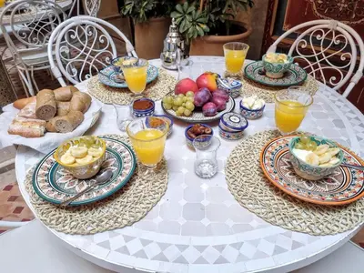 a table with plates of food and drinks on it at Riad dar serenity in Marrakech