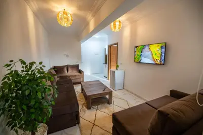 a living room with couches and a table at Jawhar Appart A3 in Marrakech