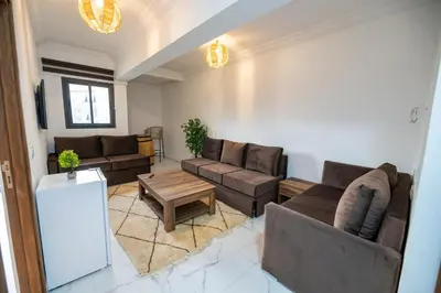 a living room with couches and a coffee table at Jawhar Appart A3 in Marrakech