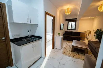 a kitchen and a living room with a kitchen and a living room at Jawhar Appart A3 in Marrakech
