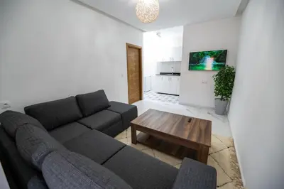 a living room with a couch and a coffee table at Jawhar Appart A4 in Marrakech