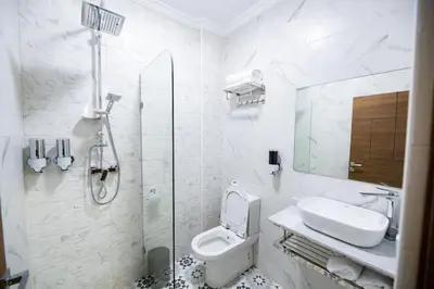 a bathroom with a toilet and a sink and a shower at Jawhar Appart A4 in Marrakech