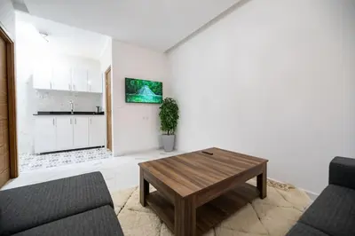 a living room with a coffee table and a kitchen at Jawhar Appart A4 in Marrakech