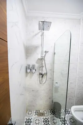 a bathroom with a shower with a toilet and a sink at Jawhar Appart A4 in Marrakech