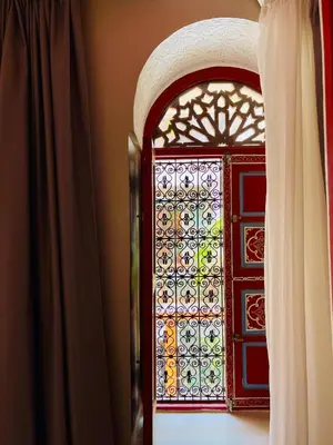 a window in a room with a curtain at Riad La Calèche in Marrakech