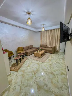 a living room with a couch and a tv at Hamza Immobiler in Marrakech